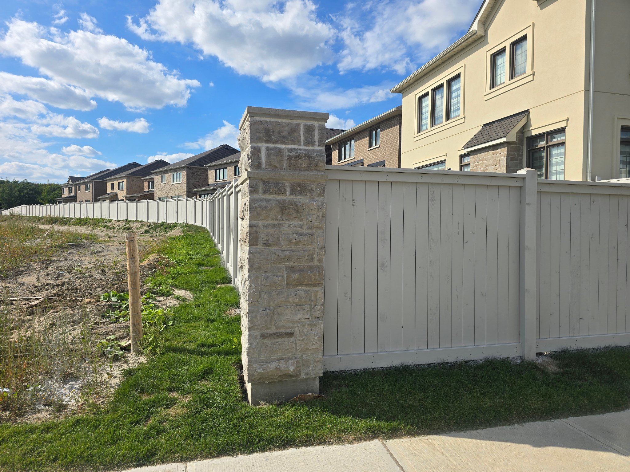 Fence staining Bradford Ontario - large subdivision fence painting project GTA