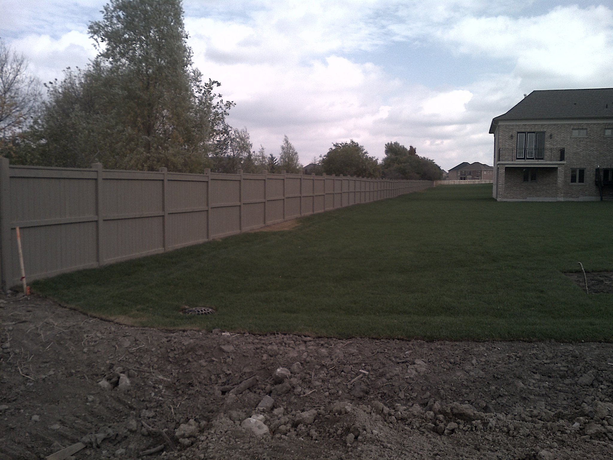 Subdivision fence staining Vaughan Ontario - large scale commercial fence painting