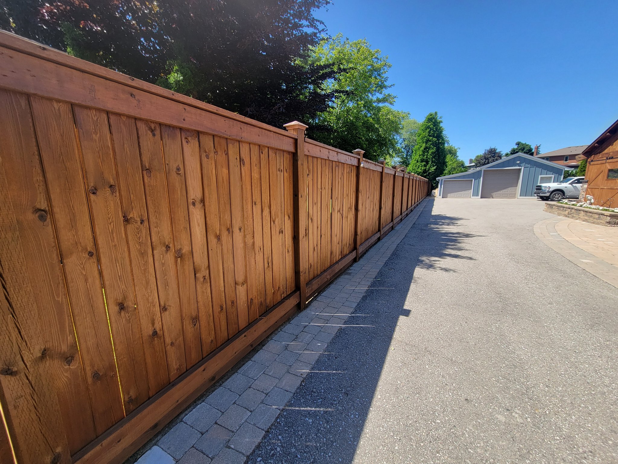 Residential fence painting Vaughan - warm brown stained privacy fence